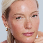 Woman with a jar of cream on a light gray background