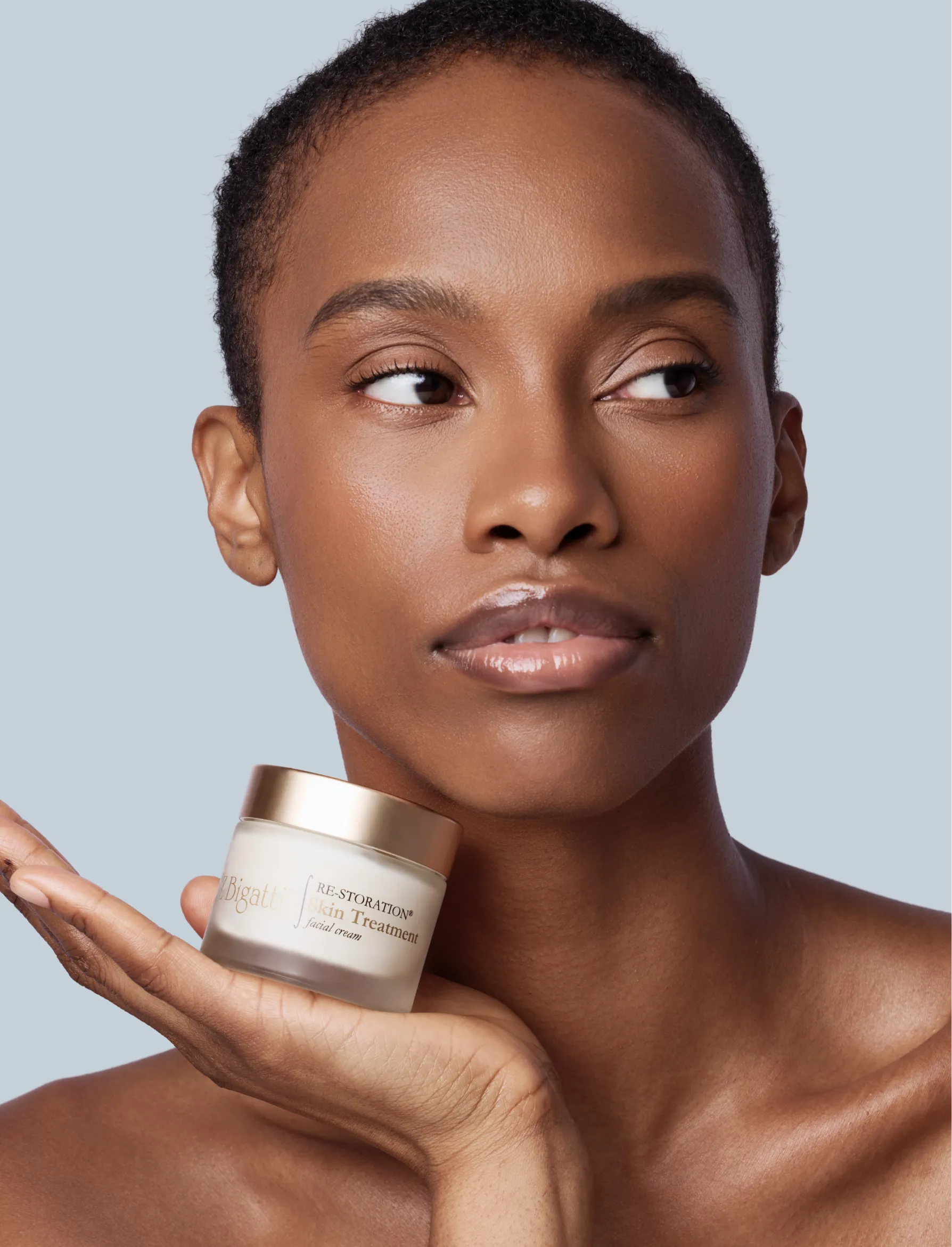African-American model holding zBigatti Skin treatment product