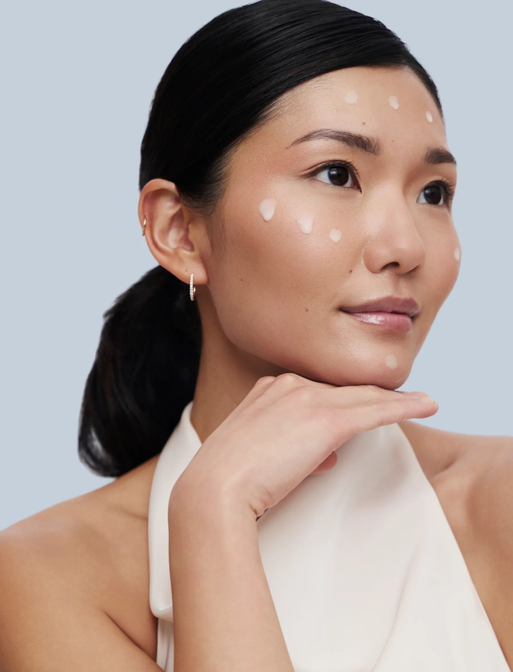 Asian woman posing with drops of zBigatti Delicate on her face