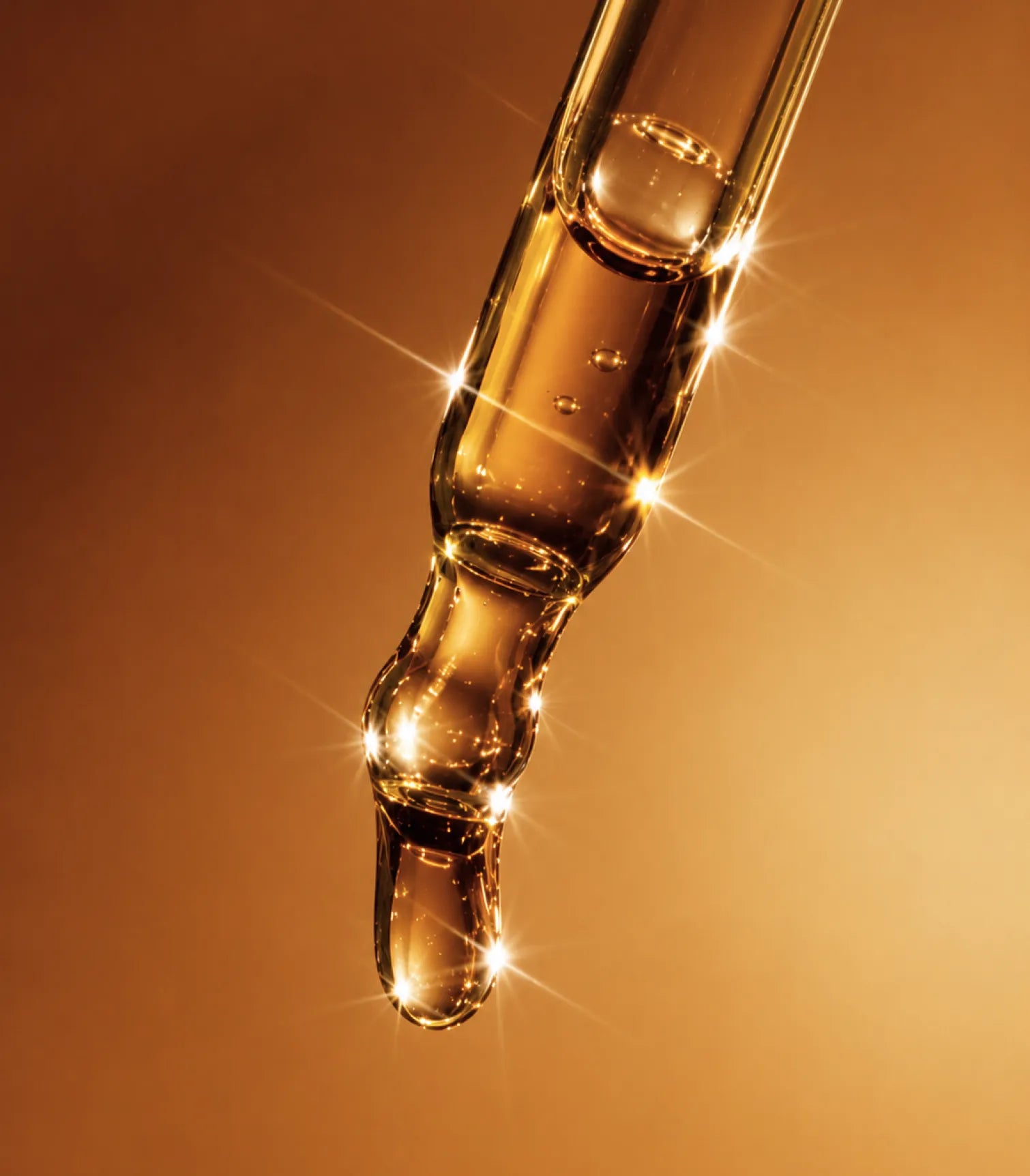 Closeup of eyedroppper on Gold Background