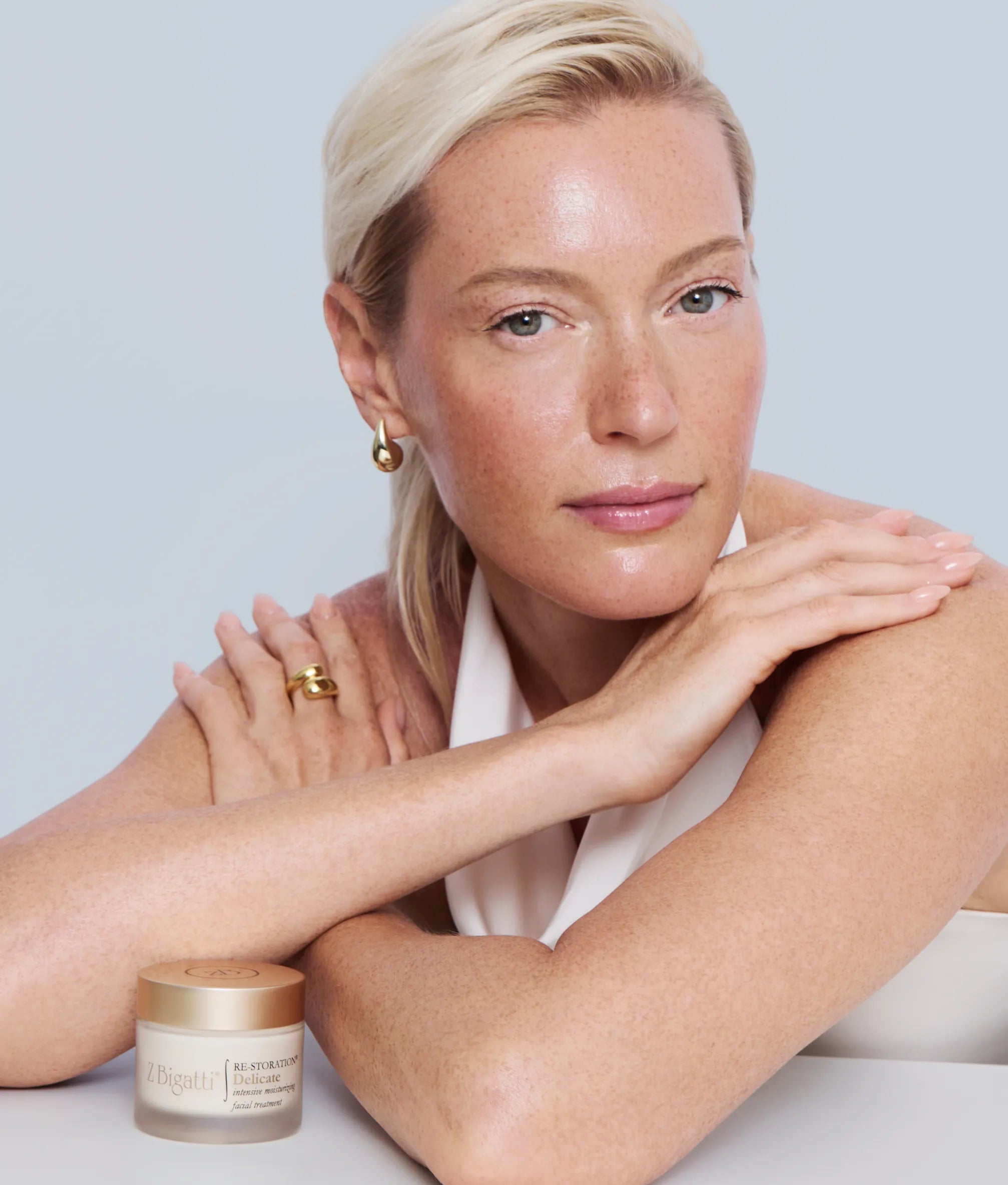 Middle-aged model with beautiful skin posing with zBigatti product