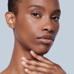 Studio Shot of an African American Woman with Moisturizer applied to skin