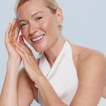 Model with soft moisturized skin posing with a smile on her face