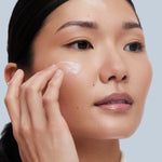 Asian Model applying Rescue serum on her face