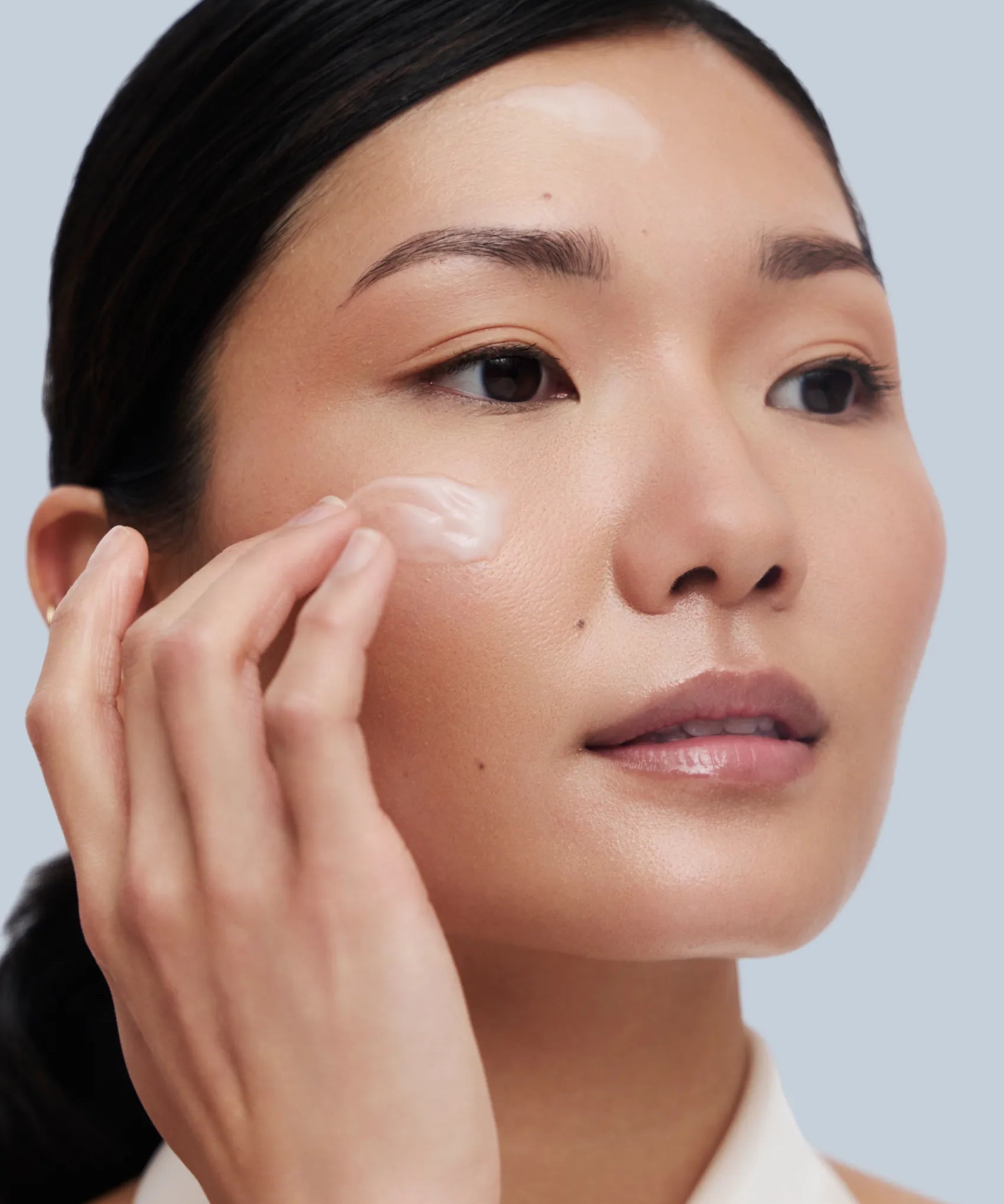 Asian Model applying Rescue serum on her face